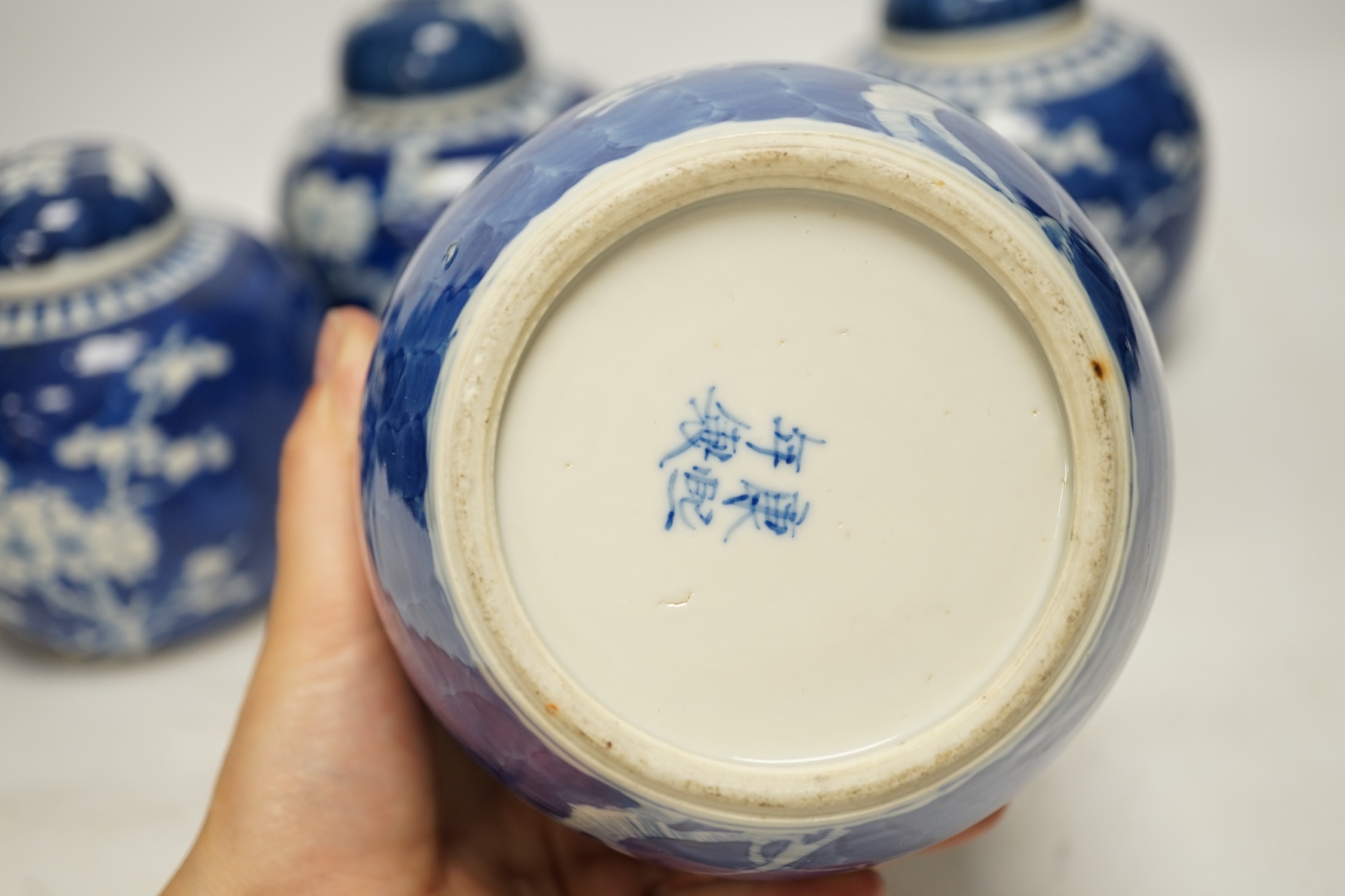 Four Chinese blue and white prunus jars and covers, tallest 15cm high. Condition - good